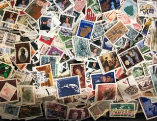 A colorful collection of various postage stamps from different eras and countries.